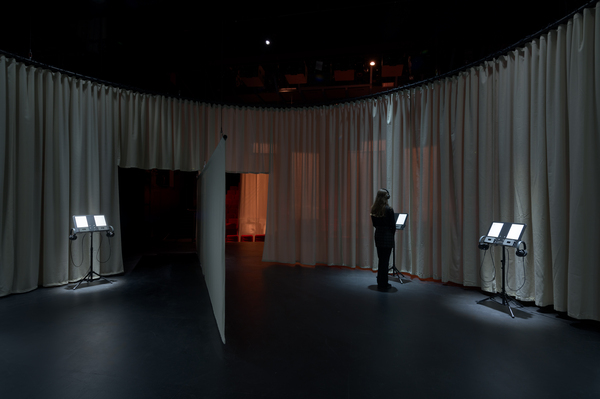Inside the circular curtain - a person listening on headphones at one of a number of listening points