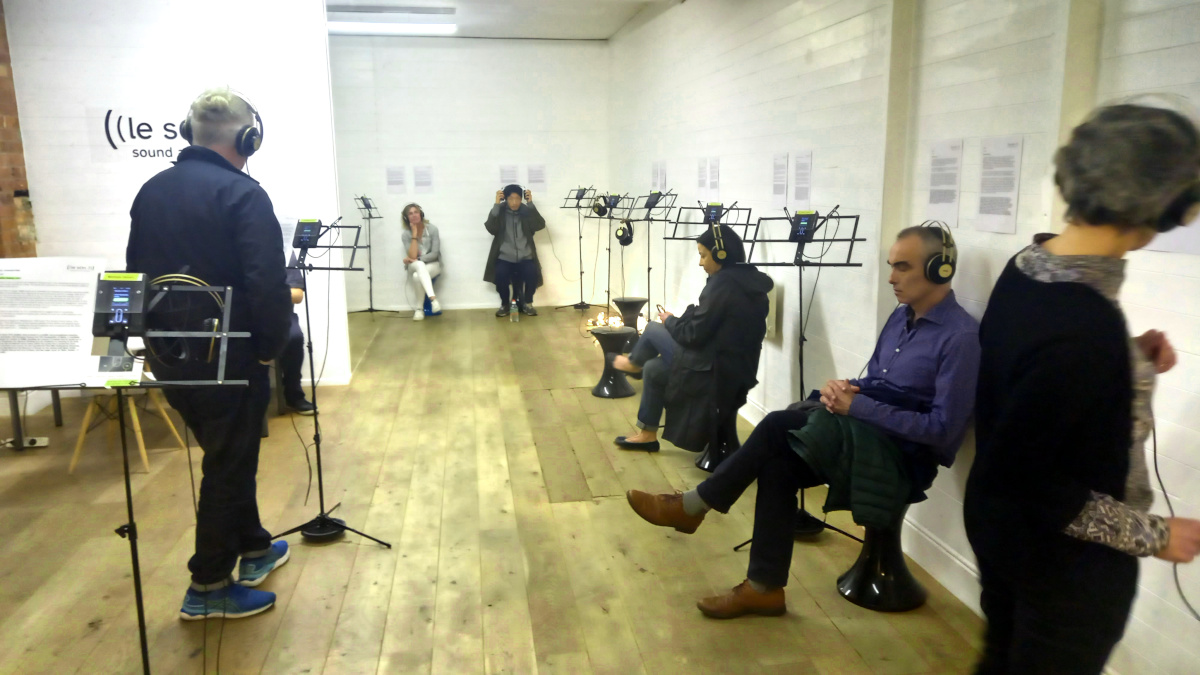 Visitors to the gallery listening to works